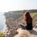 Me sitting on the cliff edge looking at the sea - featured image for weekend in Weymouth