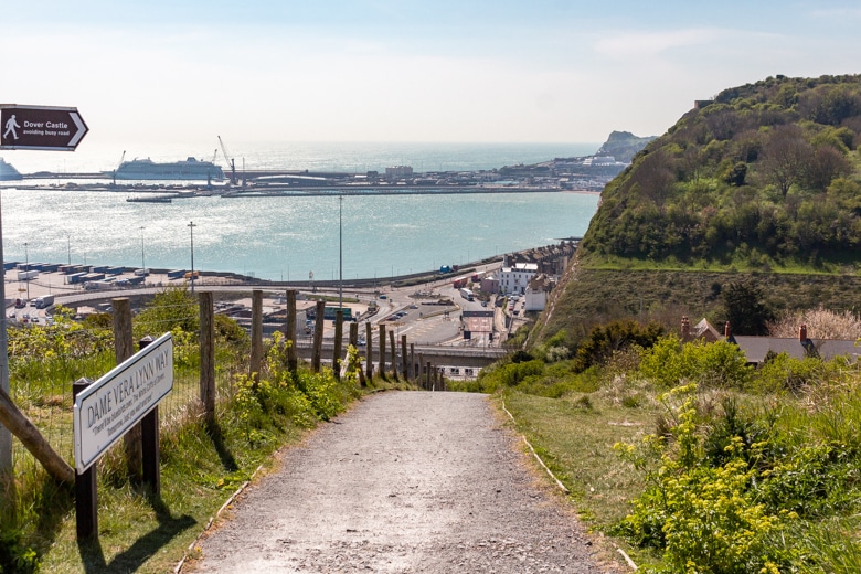 View of the steep path leading to the top of the cliffs with cliffs and the town of Dover in the background - walk from Dover to Deal